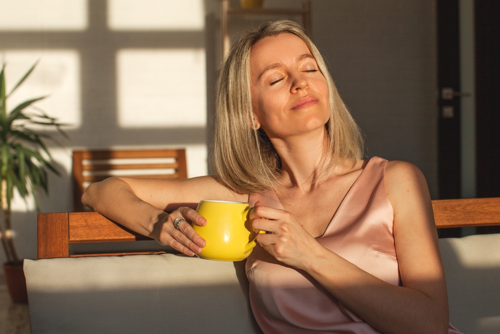 Woman enjoying sunlight, reflecting on post-operative breast lift care.