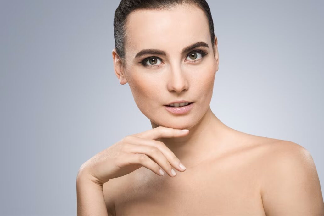 Woman with a defined jawline and balanced facial features after a chin augmentation procedure.