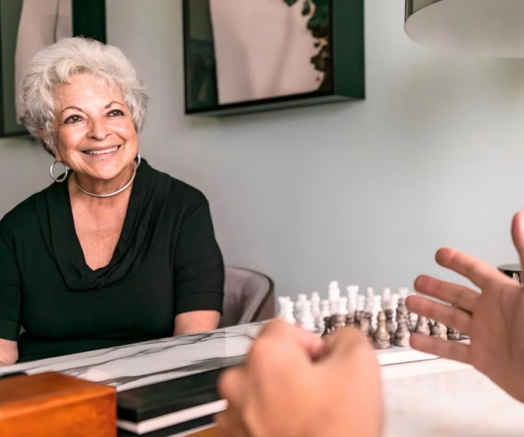 Smiling woman during an initial consultation for a deep-plane facelift, discussing goals and options.